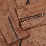 Close-up of the YKK zippers and quilted black inner lining on the cowhide leather jacket, highlighting premium craftsmanship and design